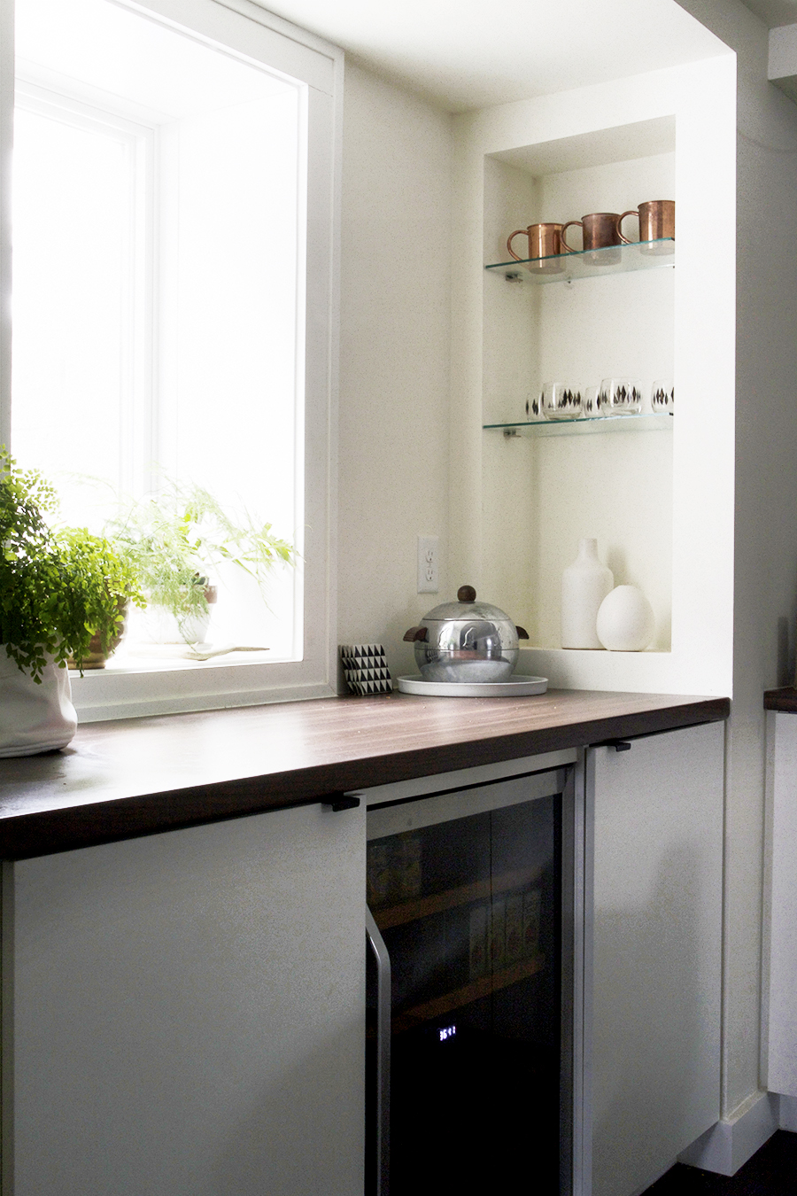 Bar with Beverage Cooler and Shelving for Glassware in a Modern Basement Remodel